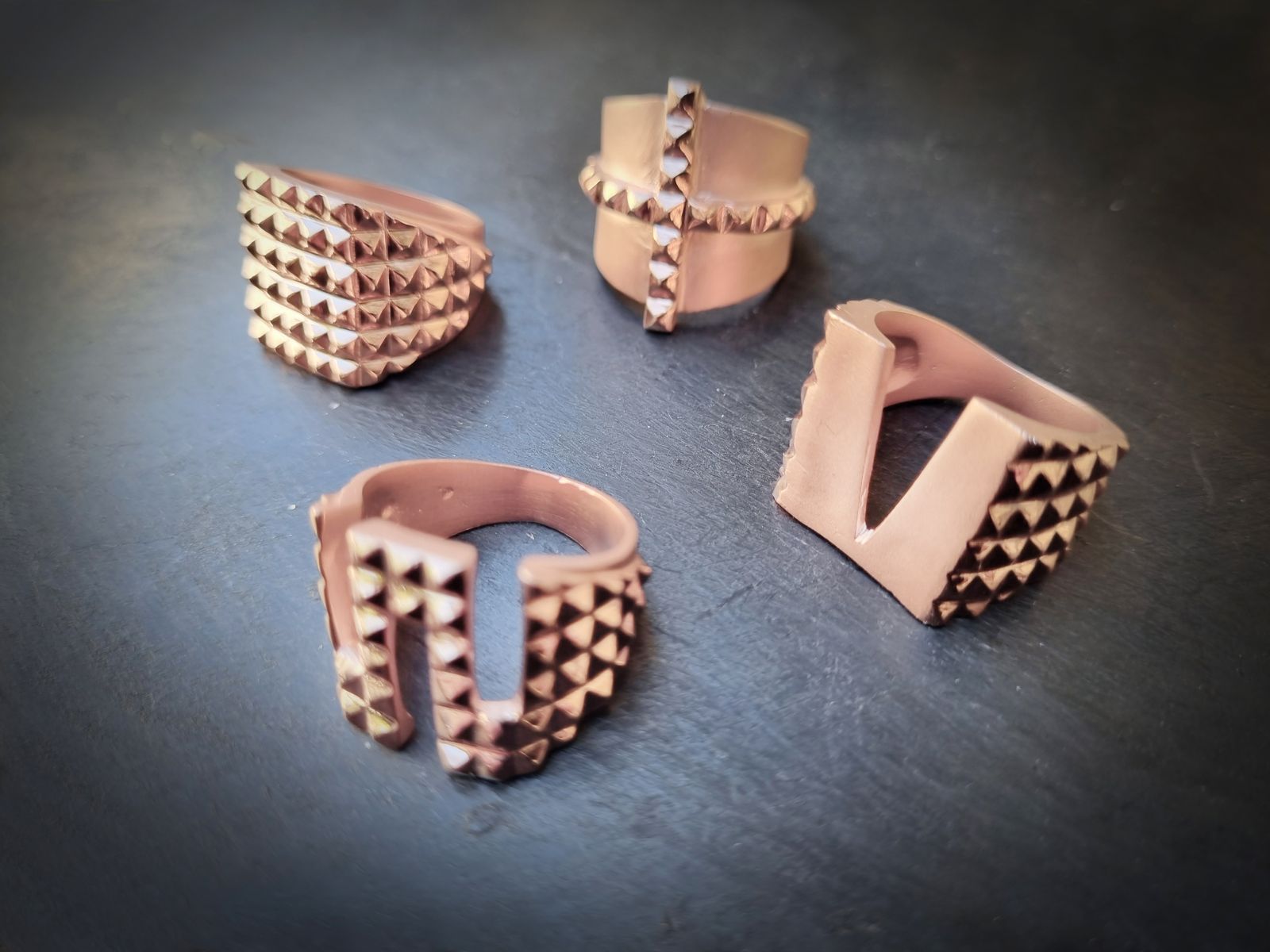 Four LEONY rose gold studded rings on stone
